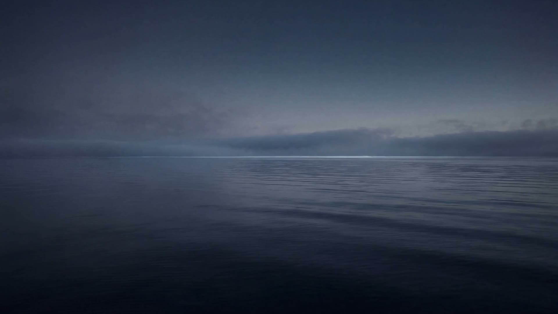 Dark water at dawn with low fog.